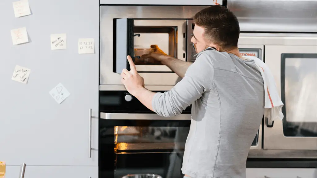 person microwaving food