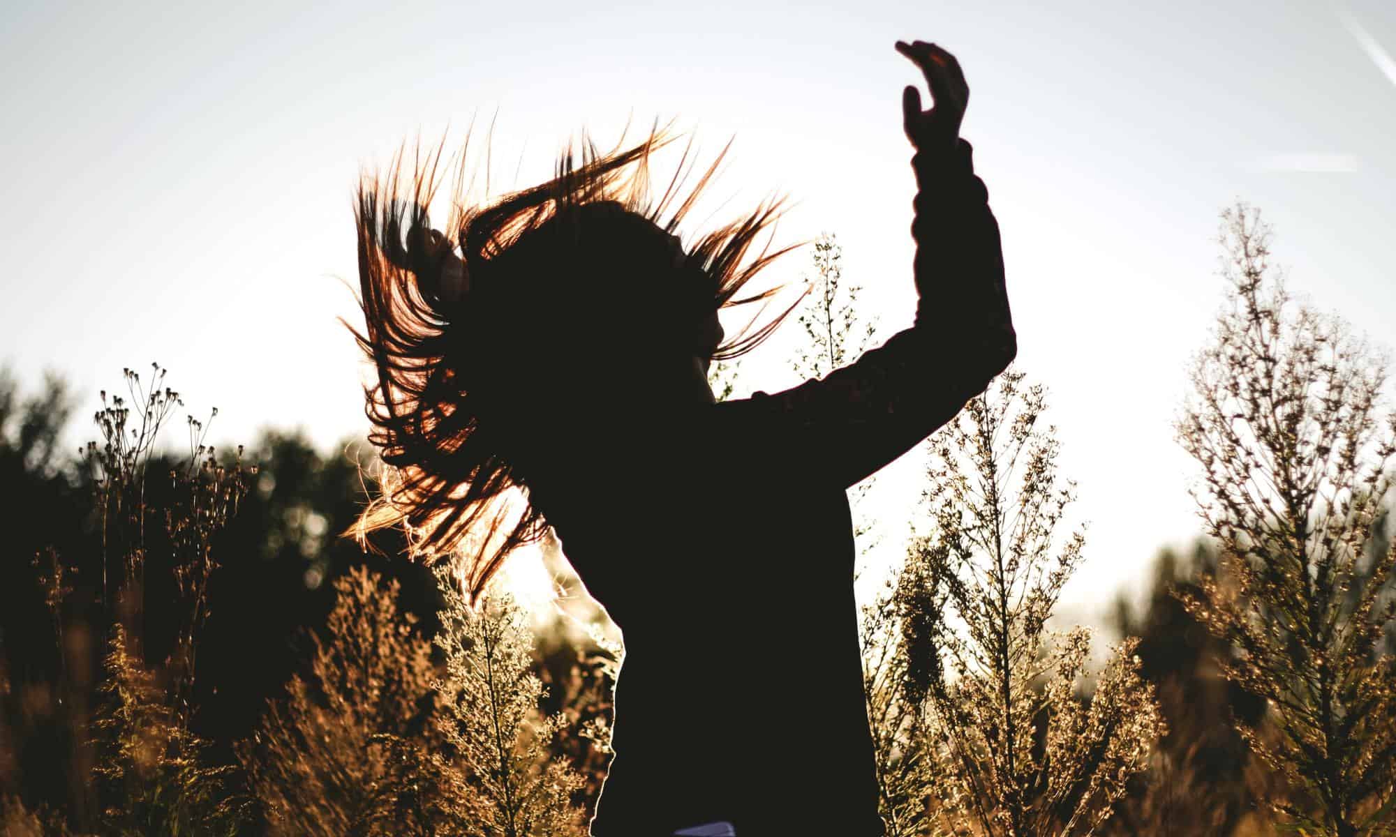 woman flipping her hair in the wind