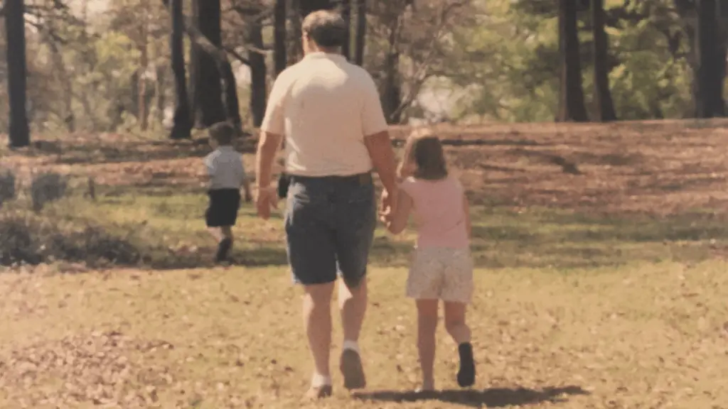 two young kids walking with grandfather