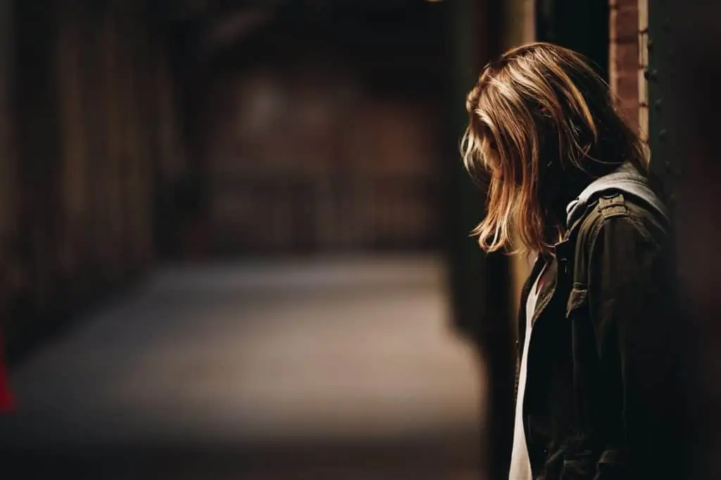 young woman searching for truth alone in a long hallway