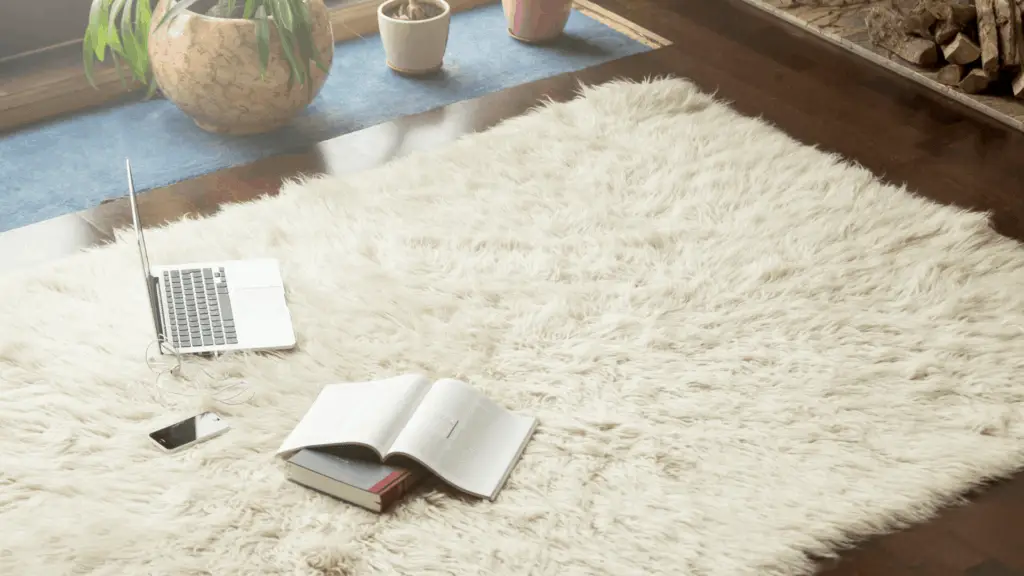 cell phone next to a book and laptop