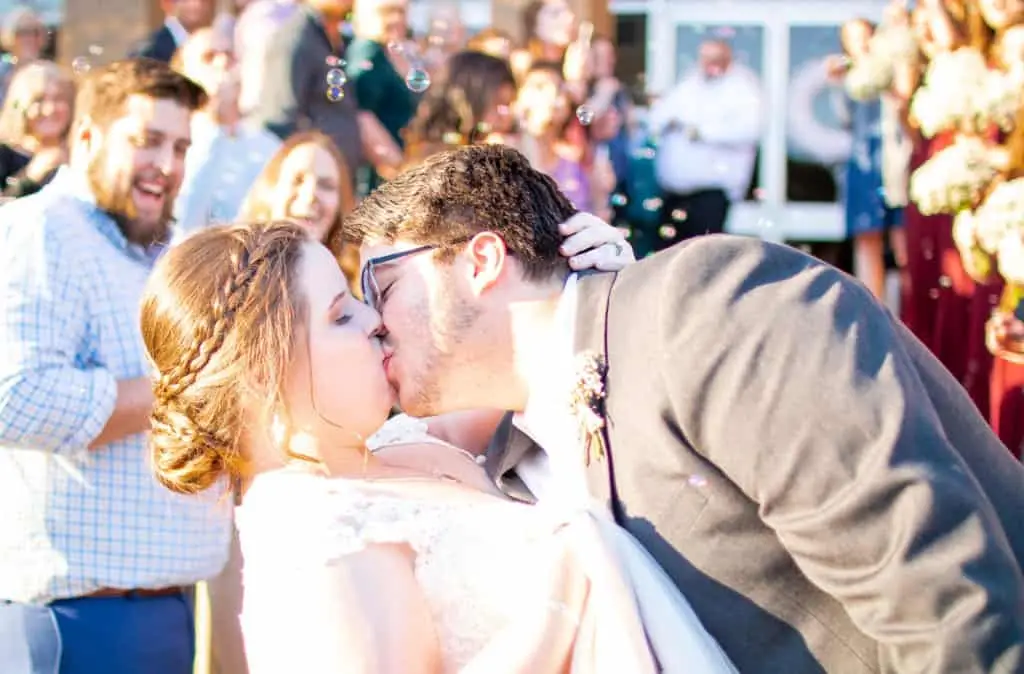 couple kissing on wedding day