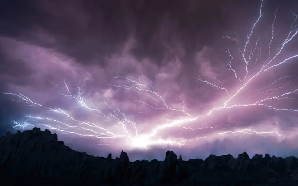 severe weather with lightning against purple and black sky