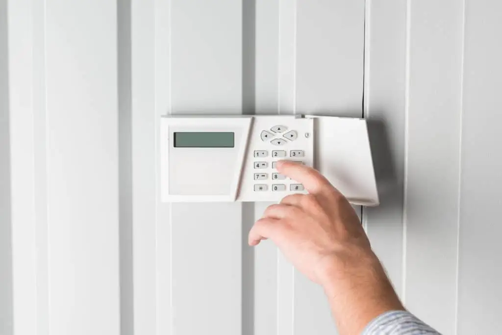 person using keypad to home security system