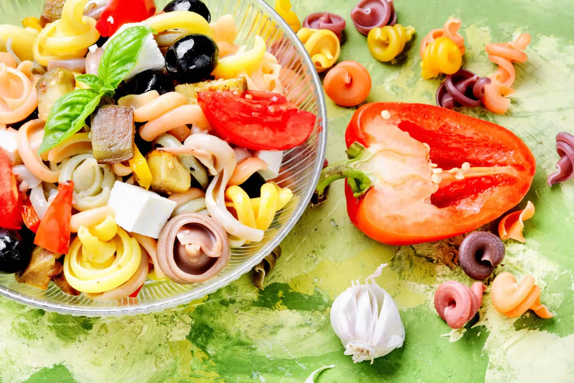 closeup of bowl of italian pasta salad and ingredients