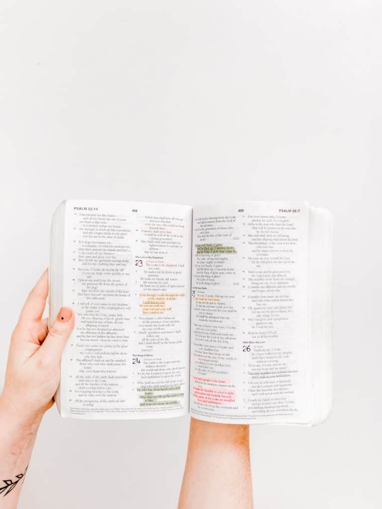 hands holding bible with highlighted verses