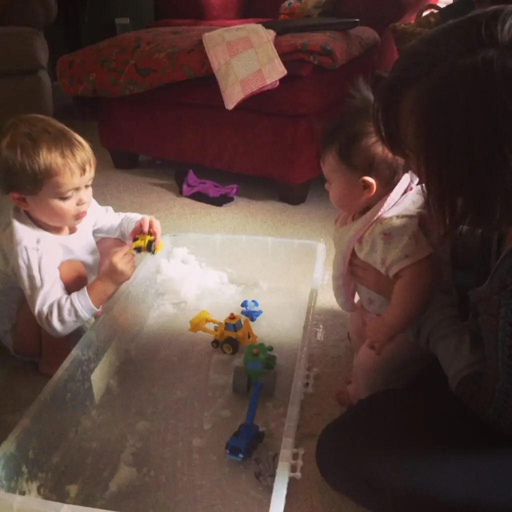 young children and mom engaging in snow day activities
