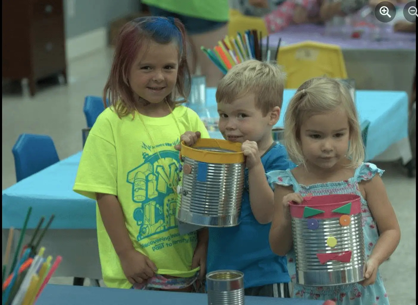 Two young girls and a boy standing together at vacation bible school