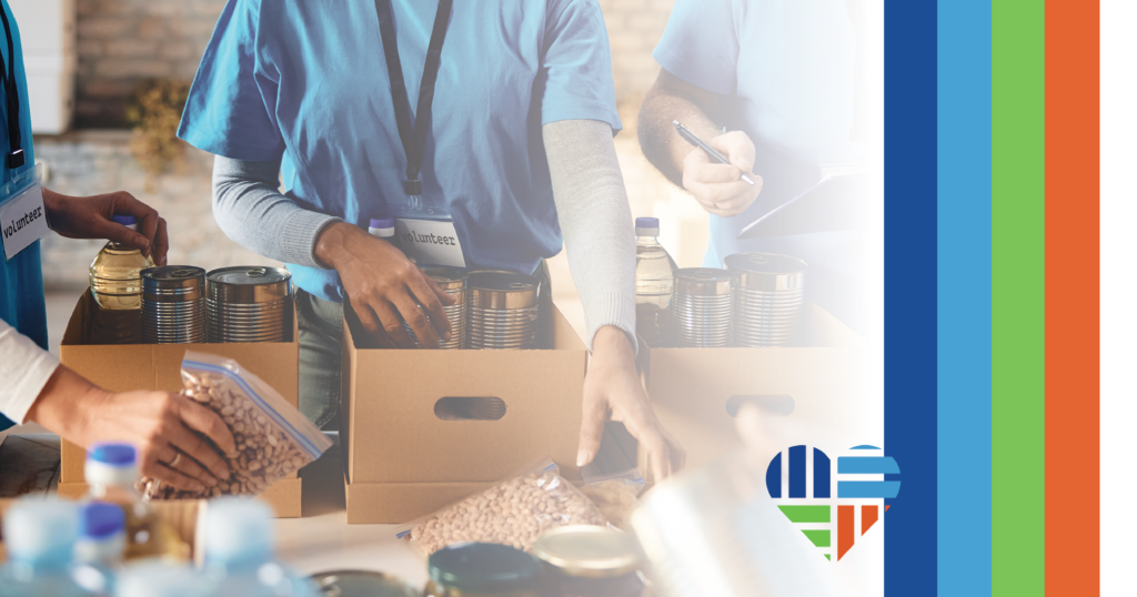 nonprofit workers fill boxes with canned goods